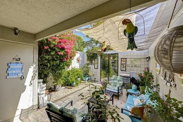 a view of a chairs and table in a patio