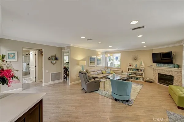 a living room with furniture a flat screen tv and a fireplace