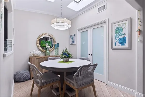 a view of a dining room with furniture and chandelier