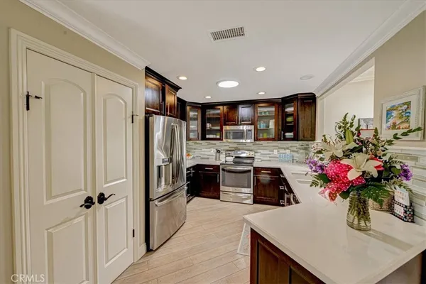 a kitchen with granite countertop stainless steel appliances and wooden cabinets