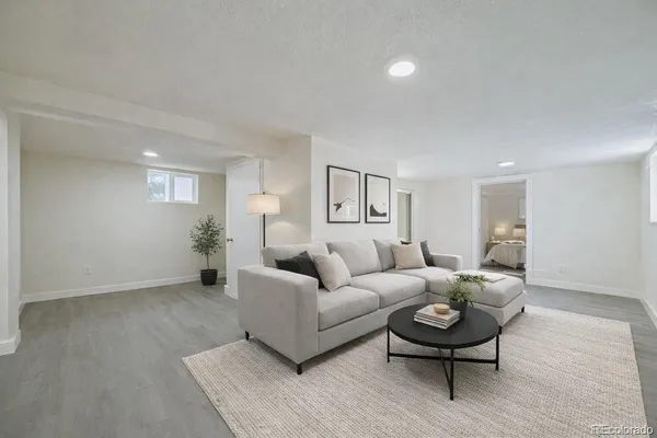 a living room with furniture and a wooden floor