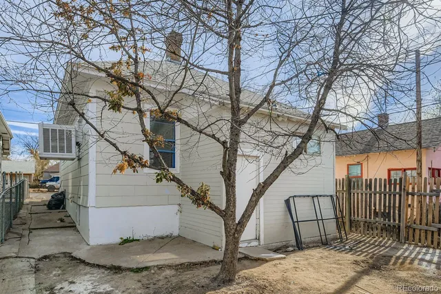 a view of a yard with a fountain and a large tree