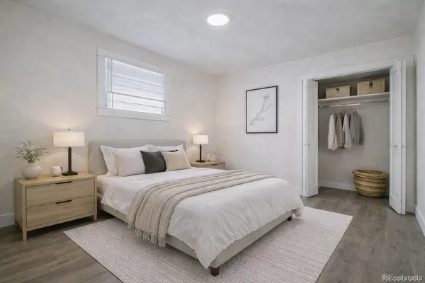 a bedroom with bed and a night stand