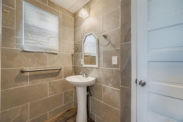 a bathroom with a sink a mirror and a shower