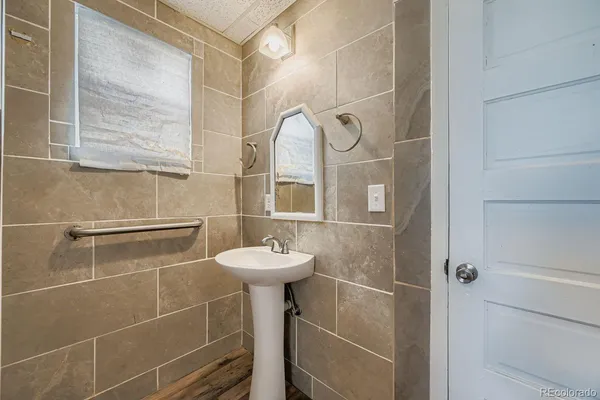 a bathroom with a sink a mirror and a shower