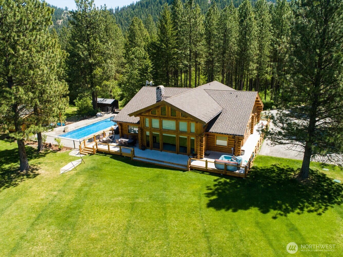 18135 River Road Leavenworth, WA 98826 - Photo 1 of 39 a view of house with garden and tall trees