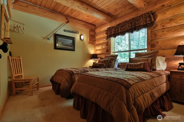 a bedroom with a bed chair and window