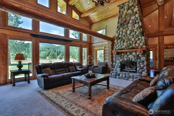 a living room with furniture a fireplace and a table