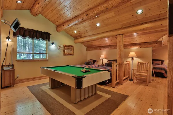 a room with pool table and windows