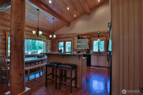 a dining room with furniture and wooden floor