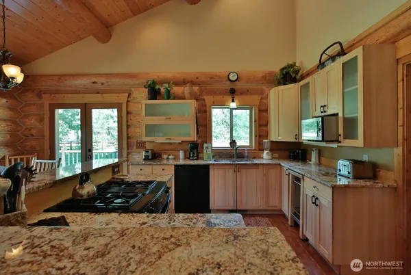 a kitchen with a sink stove and cabinets