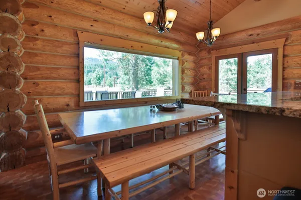 a view of a dining room with furniture window and outside view