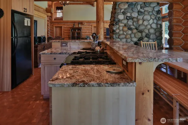 a kitchen with stainless steel appliances granite countertop a stove and a refrigerator