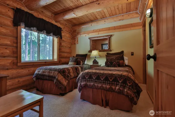 a bedroom with a bed window and a chair