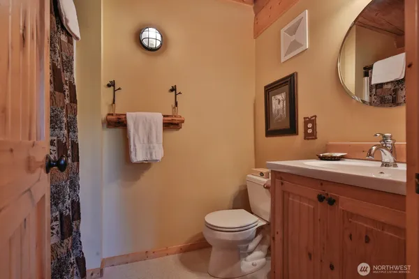 a bathroom with a toilet a sink and mirror