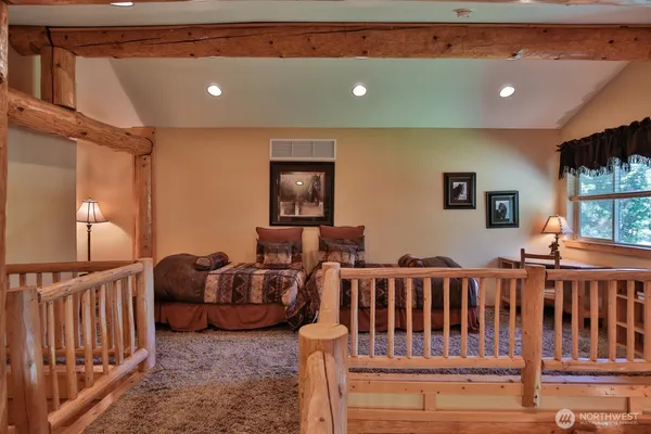 a living room with furniture stairs and a flat screen tv