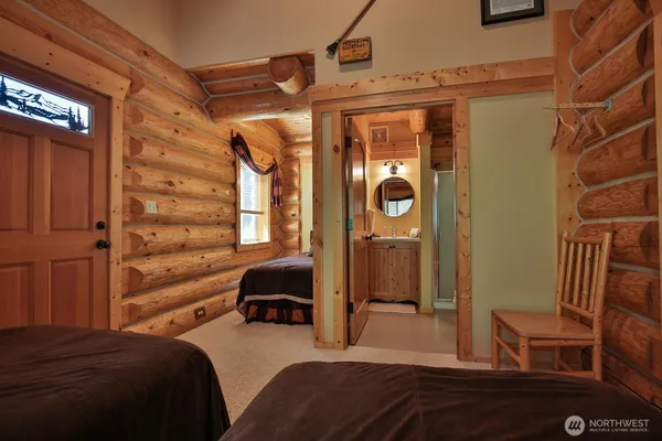 a bedroom with a bed and a mirror