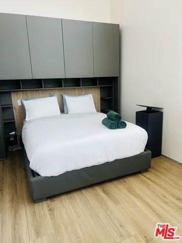 a bed sitting in a bedroom next to a larger window