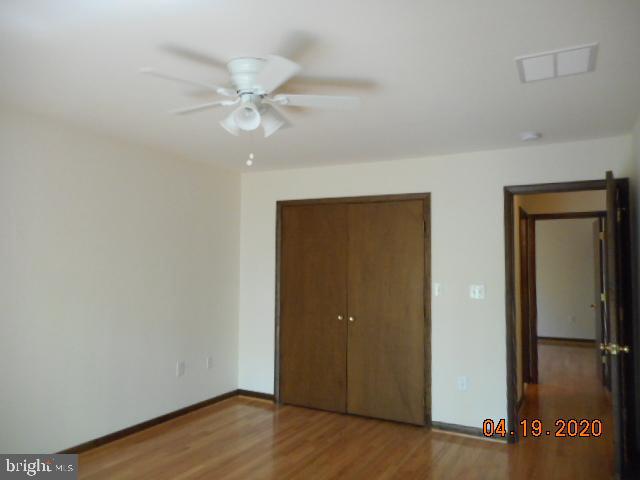 3200 Hickory Ridge Road Dunkirk, MD 20754 - Photo 29 of 44 an empty room with wooden floor and fan