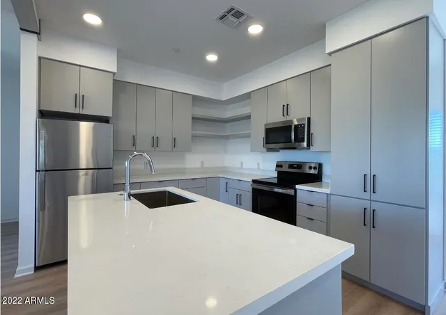a kitchen with a refrigerator sink and microwave