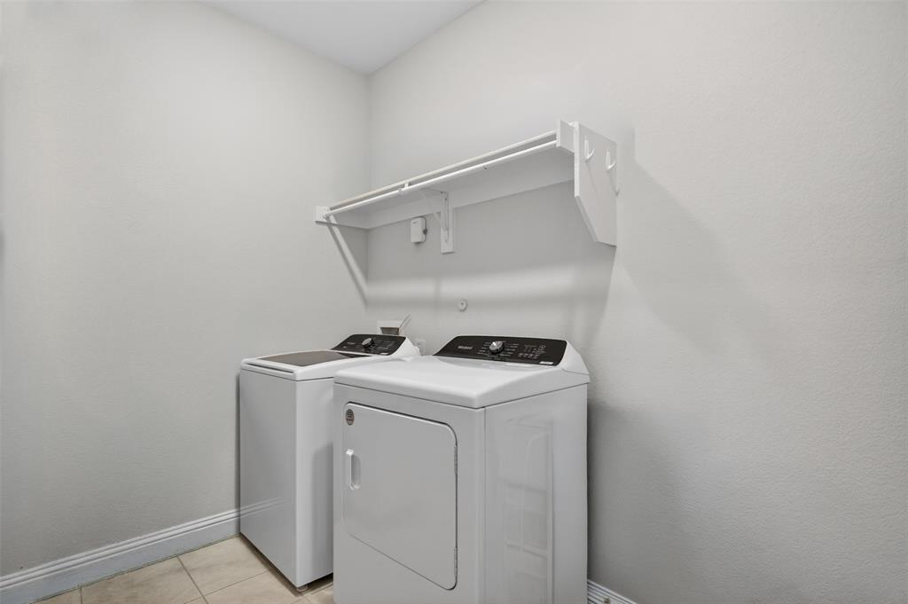 1002 Coppersmith Way Forney, TX 75126 - Photo 23 of 39 a utility room with dryer and washer