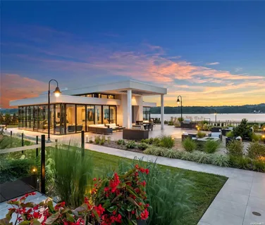 a view of a house with backyard outdoor seating and lake