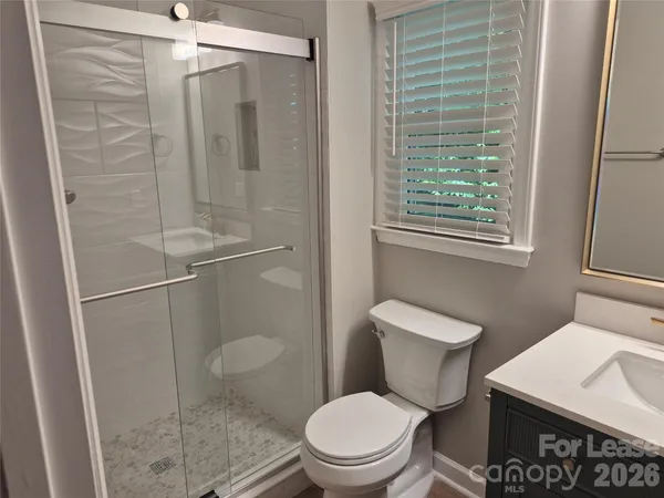 a white toilet sitting next to a bathroom sink