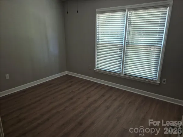 an empty room with wooden floor