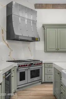 a living room with furniture a chandelier and a fireplace