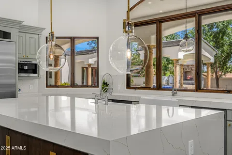 a living room with furniture a chandelier and a fireplace
