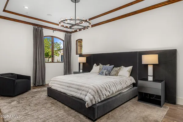a living room with furniture a flat screen tv and a floor to ceiling window