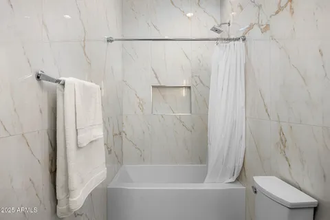 an aerial view of residential houses with outdoor space and street view