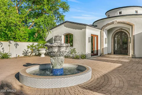 a dining room with wooden floor a chandelier a glass table and chairs