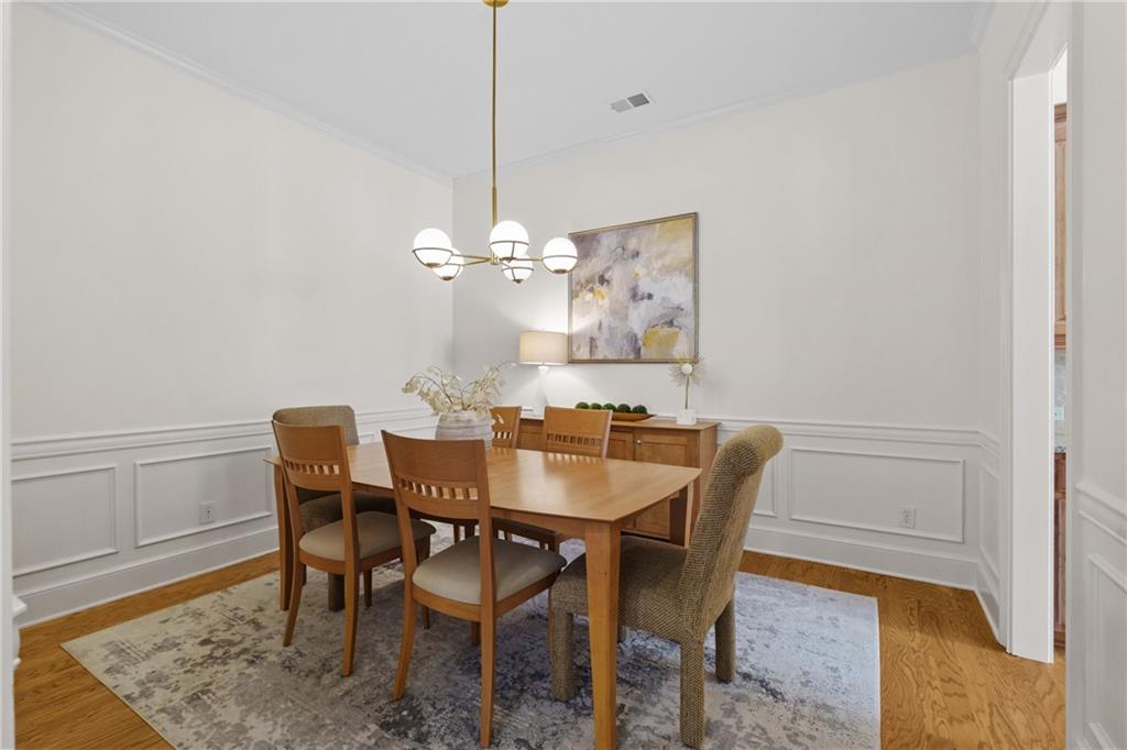 11945 Dancliff Trace Alpharetta, GA 30009 - Photo 15 of 48 a view of a dining room with furniture and wooden floor