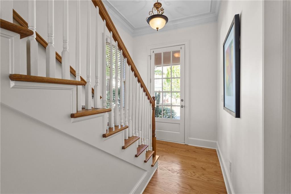11945 Dancliff Trace Alpharetta, GA 30009 - Photo 18 of 48 a view of entryway and hall with wooden floor