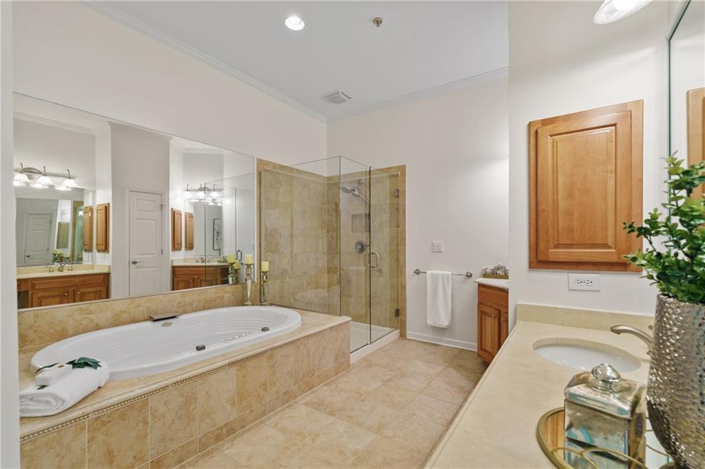 11945 Dancliff Trace Alpharetta, GA 30009 - Photo 24 of 48 a spacious bathroom with a granite countertop tub sink and mirror