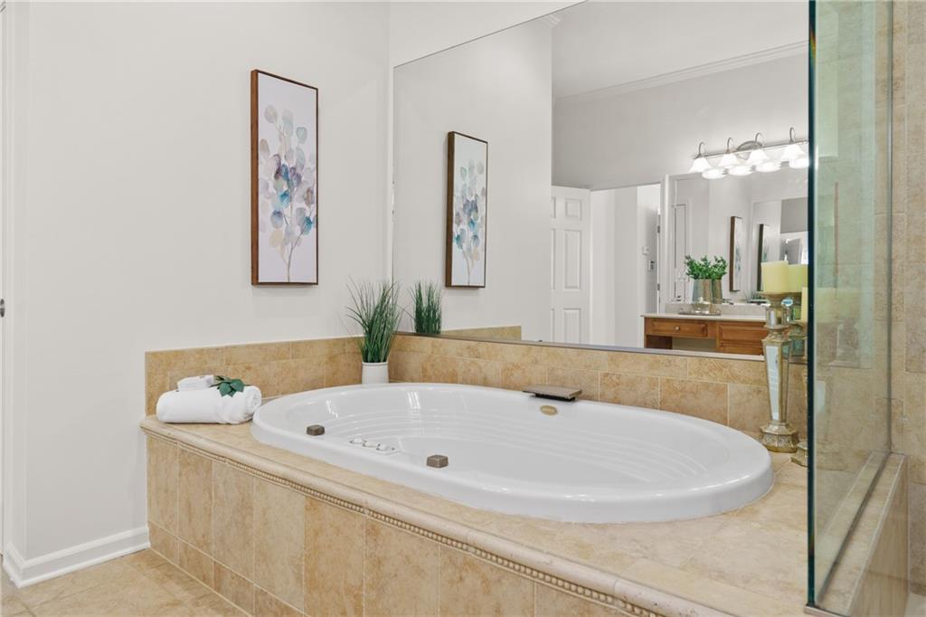 11945 Dancliff Trace Alpharetta, GA 30009 - Photo 26 of 48 a bathroom with a bathtub and shower