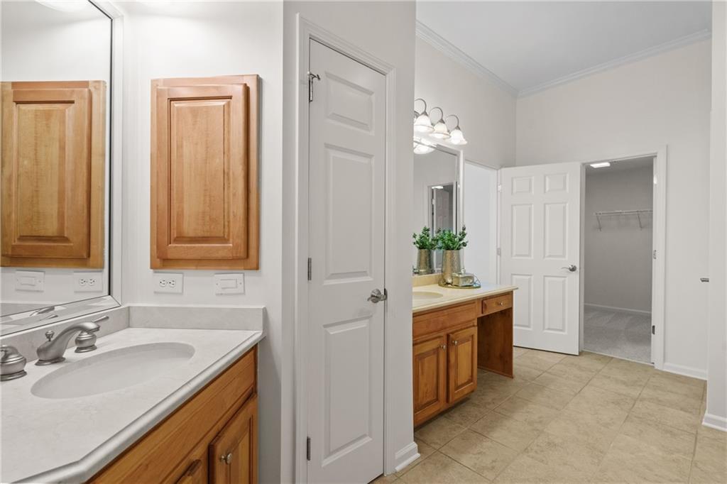11945 Dancliff Trace Alpharetta, GA 30009 - Photo 27 of 48 a spacious bathroom with a double vanity sink and a mirror