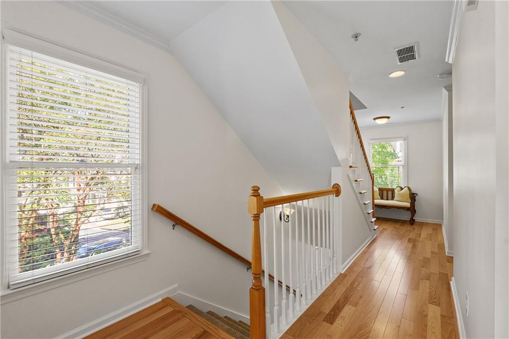 11945 Dancliff Trace Alpharetta, GA 30009 - Photo 29 of 48 a view of hallway with wooden floor and stairs