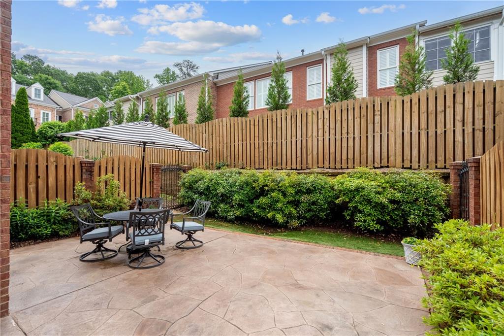 11945 Dancliff Trace Alpharetta, GA 30009 - Photo 3 of 48 a view of a chairs and table in the back yard of the house