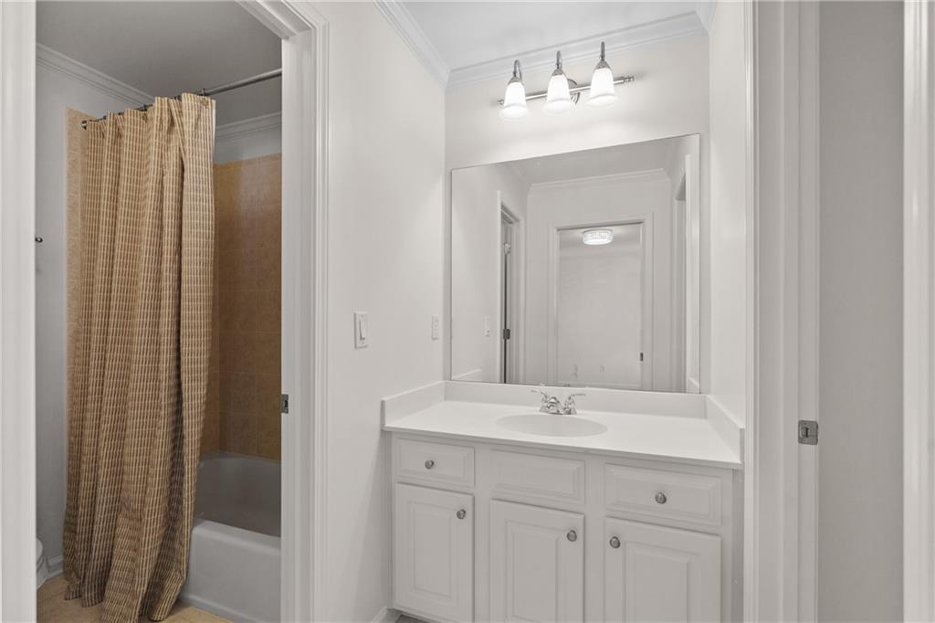 11945 Dancliff Trace Alpharetta, GA 30009 - Photo 33 of 48 a bathroom with a double vanity sink and a mirror