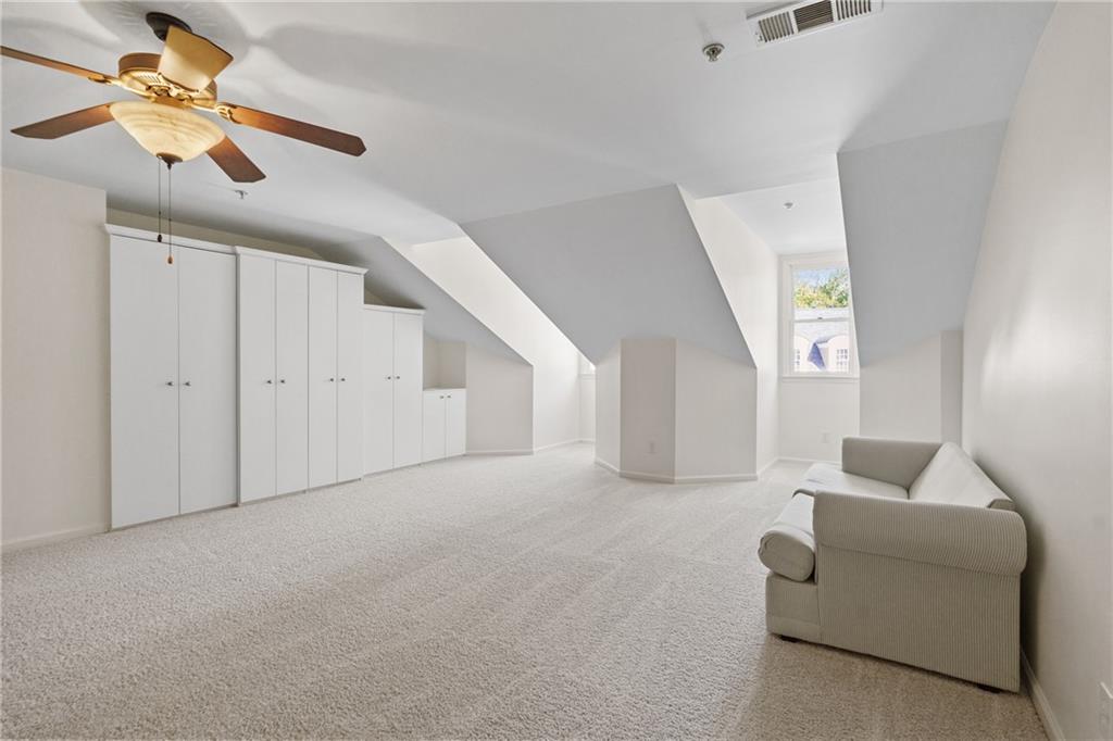 11945 Dancliff Trace Alpharetta, GA 30009 - Photo 36 of 48 a living room with furniture and a ceiling fan