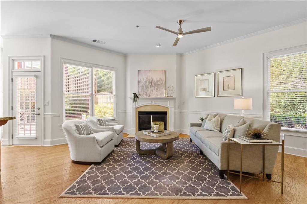 11945 Dancliff Trace Alpharetta, GA 30009 - Photo 4 of 48 a living room with furniture and a fireplace