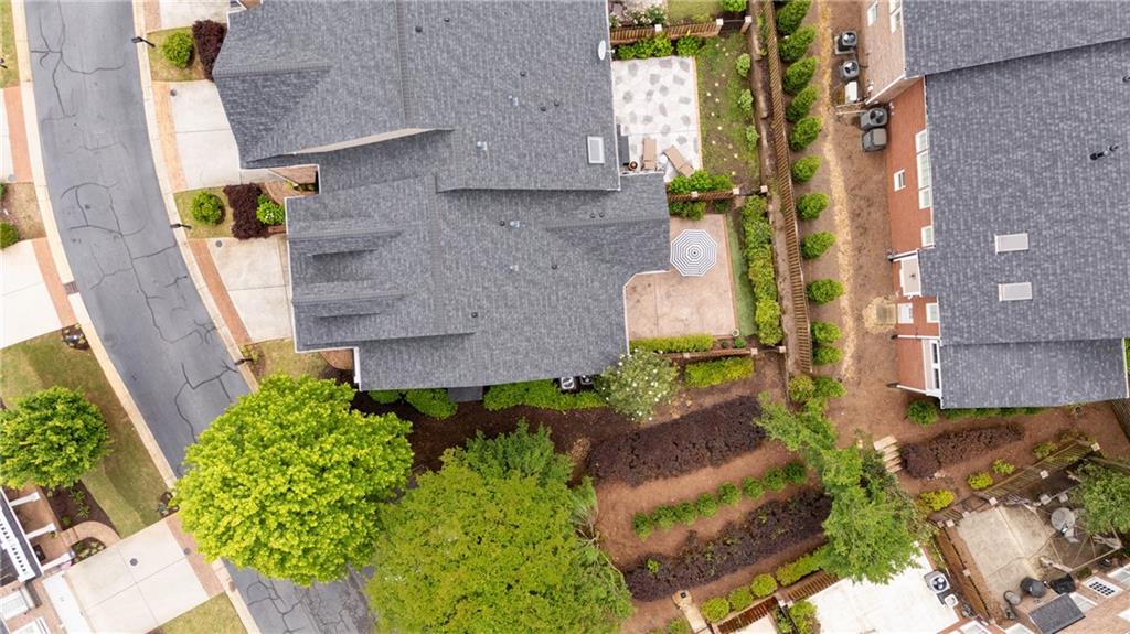 11945 Dancliff Trace Alpharetta, GA 30009 - Photo 42 of 48 an aerial view of a house with a yard and large trees