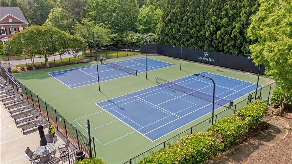 11945 Dancliff Trace Alpharetta, GA 30009 - Photo 44 of 48 a view of a tennis ground with large trees