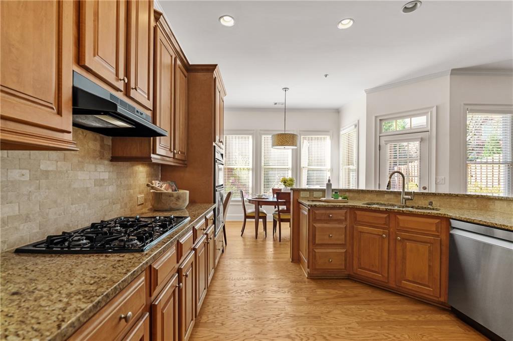11945 Dancliff Trace Alpharetta, GA 30009 - Photo 10 of 48 a kitchen with lots of counter top space and stainless steel appliances