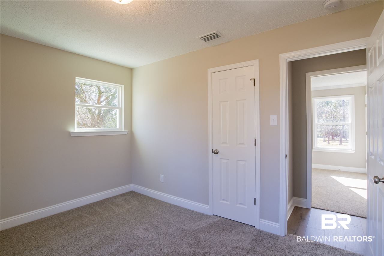 9141 Semmes Court Semmes, AL 36575 - Photo 18 of 28 Two guest bedrooms that have new carpet and paint.