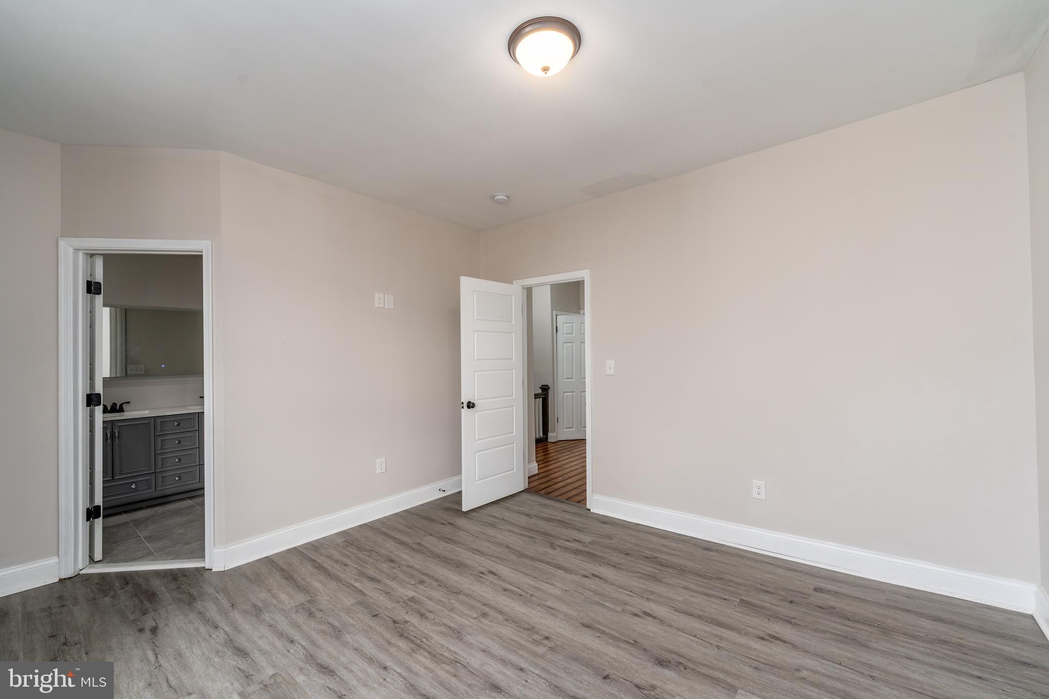 3506 Reisterstown Road Baltimore, MD 21215 - Photo 14 of 32 a view of an empty room with wooden floor and a window