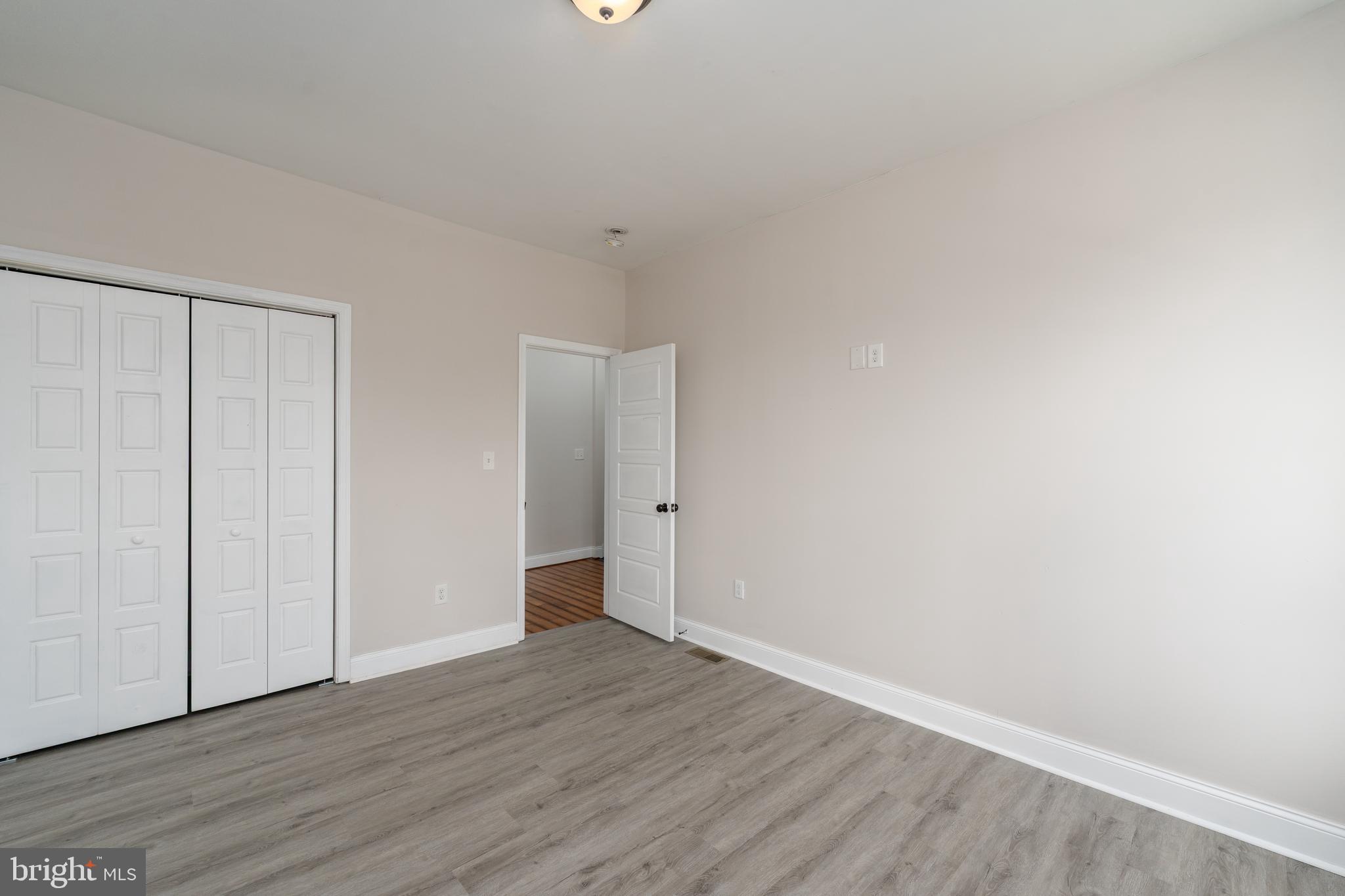 3506 Reisterstown Road Baltimore, MD 21215 - Photo 18 of 32 a view of an empty room with wooden floor