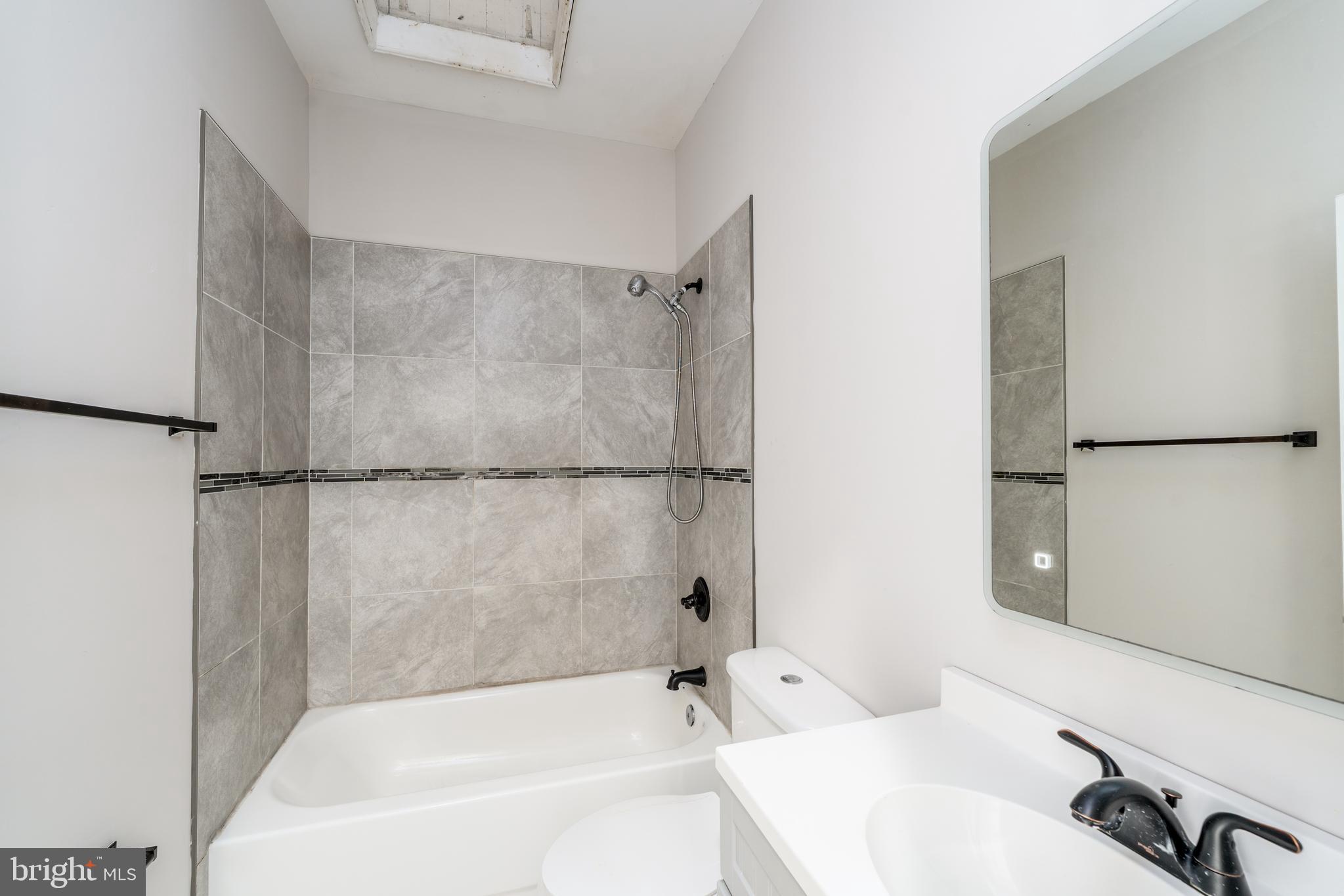 3506 Reisterstown Road Baltimore, MD 21215 - Photo 22 of 32 a bathroom with a bathtub and a shower